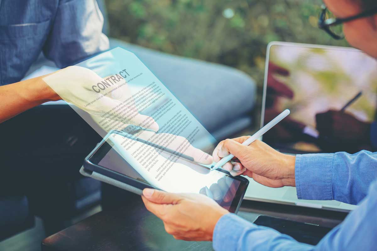 Person using a stylus to electronically sign a digital agreement on a tablet.